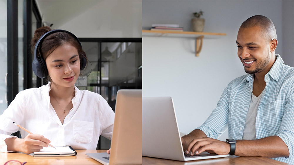 Student on left wearing headphones, holding pen and writing on paper wile looking at laptop screen. Another student on right, typing on a laptop computer.